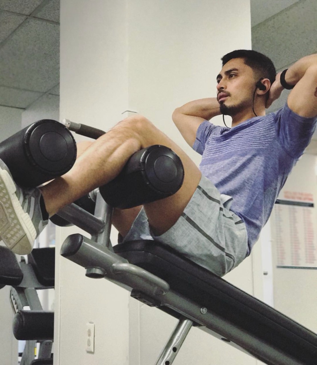 Benjamin training on an incline bench in the gym